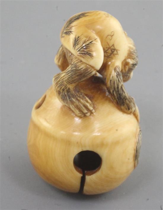 A Japanese ivory netsuke, carved with a monkey crouching on a bell, late 19th/early 20th century 4.3cm